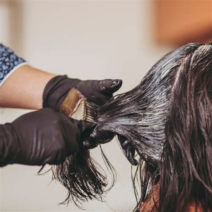 What should be the first step in applying hair color?